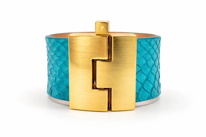 Turquoise bracelet with gold clasp on a white background
