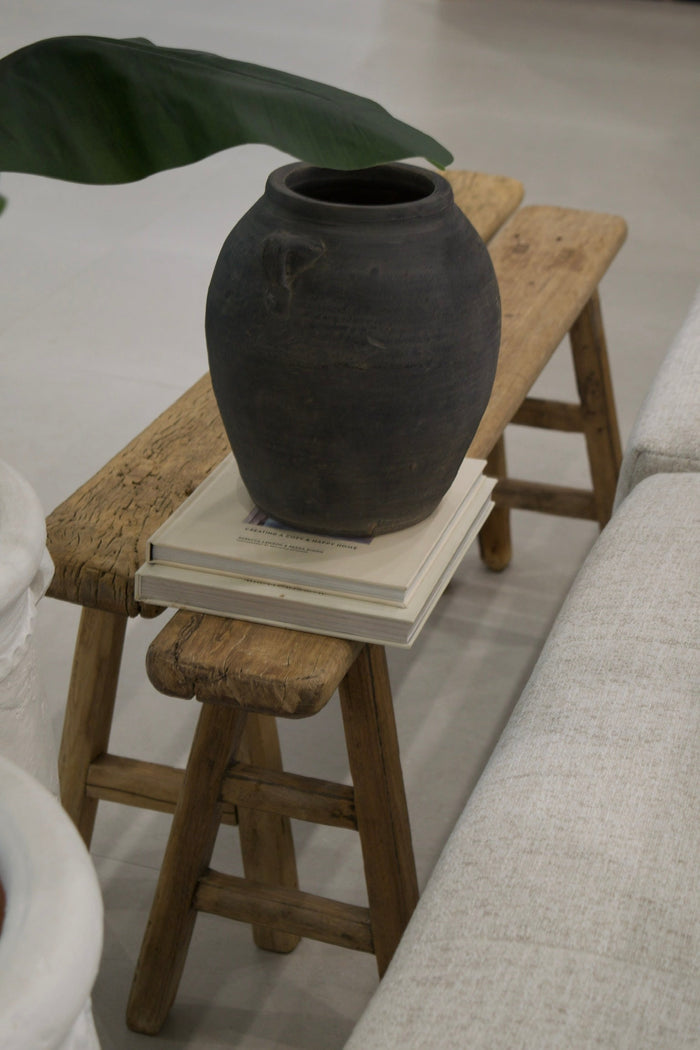 Narrow Elm Display Bench — bench beside a sofa with a dark vessel and books; Canggu Home