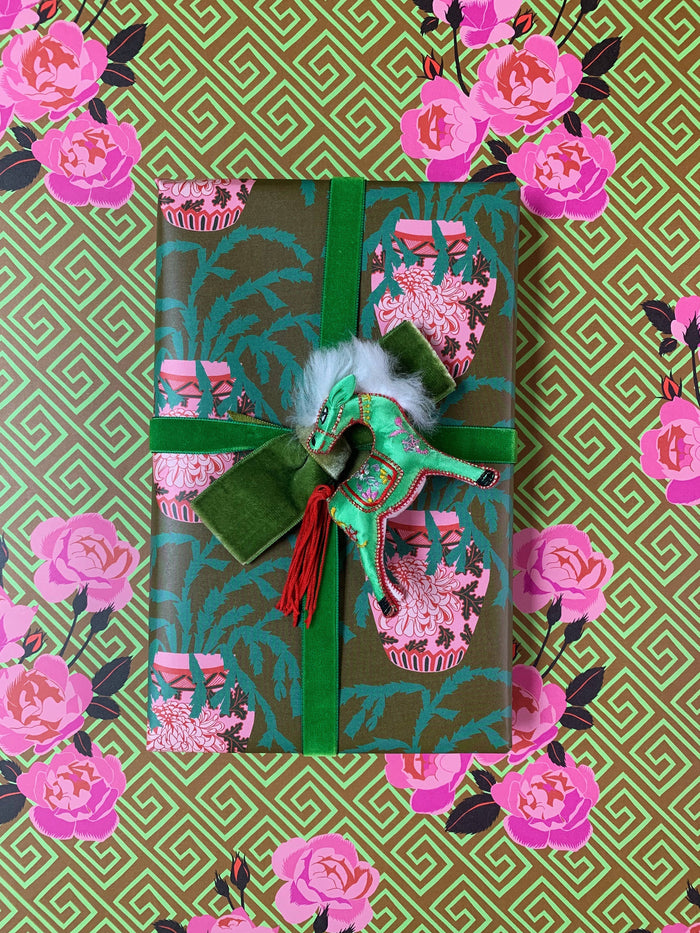 Gift box with decorative bow on a floral patterned background
