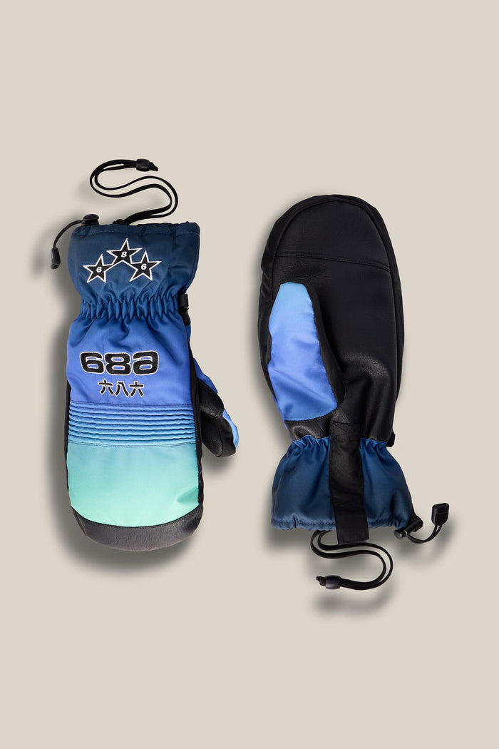 Two 686 Men’s Lander™ Mitts in blue, green, and black with star designs, drawstrings, and an embroidered 686 logo are displayed on a light beige background—one showing the front and the other showing the palm side.