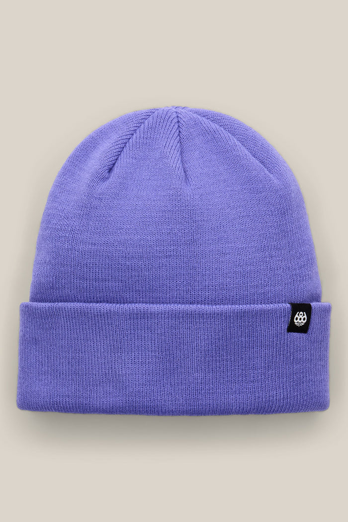 The 686 Standard Roll Up Beanie by 686 is a lavender knit hat featuring a folded brim and a small black tag with a white logo, shown against a light beige background.