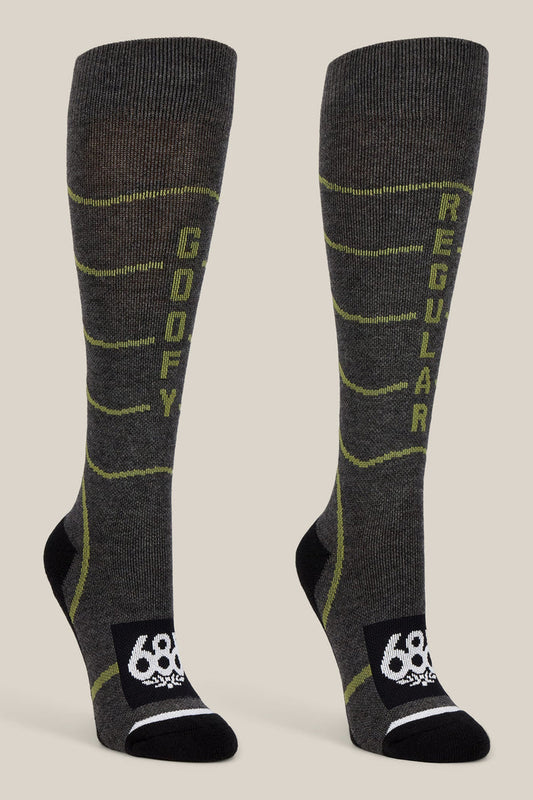 The 686 Women’s Contour Merino Sock - 2-Pack by 686 features a pair of gray knee-high performance socks for women, designed with yellow-green accents. The left sock is labeled “GOOFY” while the right reads “REGULAR.” Both socks showcase a black toe and heel area, a white 686 logo on the foot, and are crafted for both comfort and style.