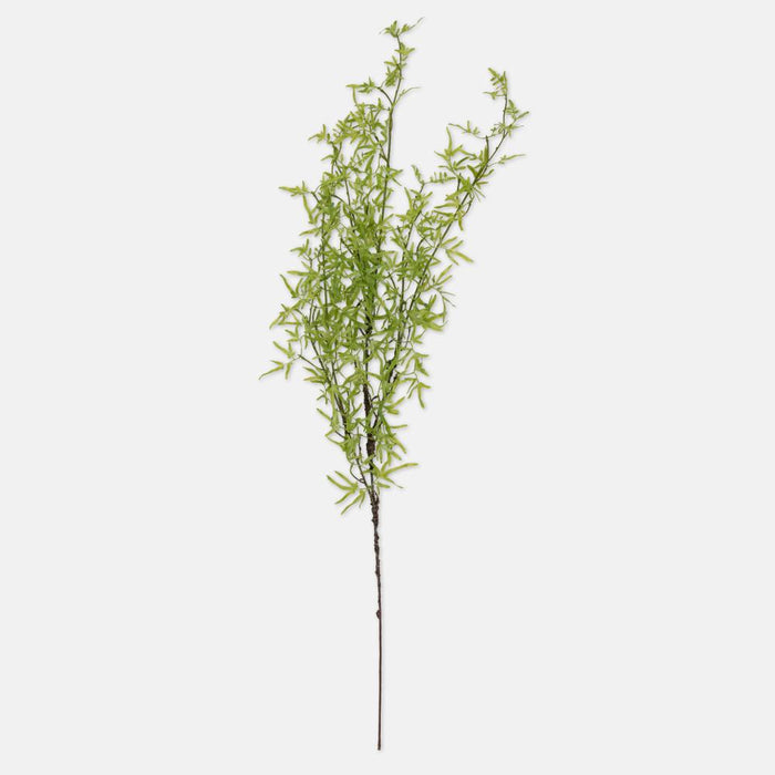 Artificial green plant branch on a white background