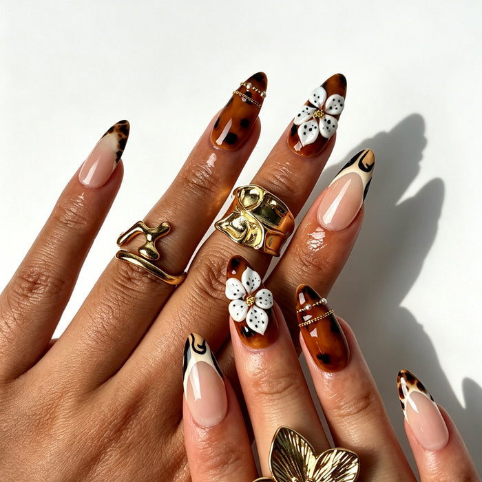 Retro western almond false nails, sheer nude base, tortoiseshell amber ombre, tiger French tips and 3D flowers