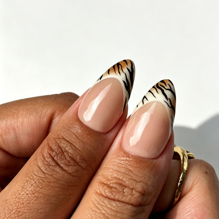 Bold almond press on nails, sheer nude base, tortoiseshell ombre, tiger French tip, 3D flower, gold chain and pearl
