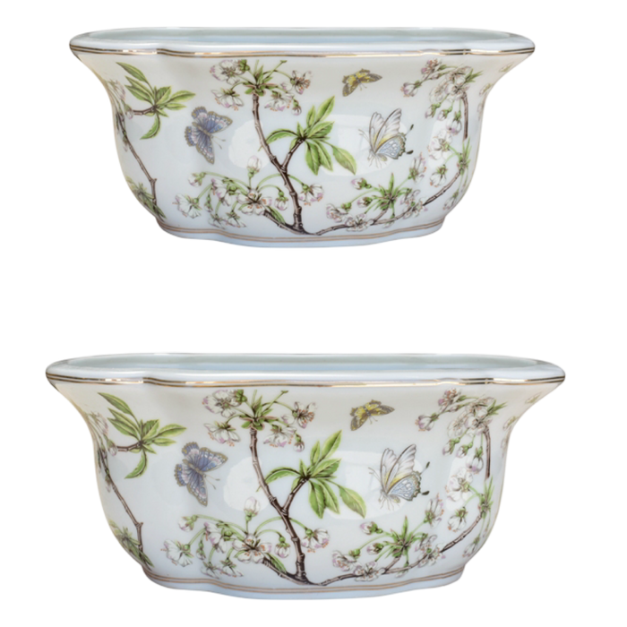 Two ceramic planters with floral and butterfly design on a white background