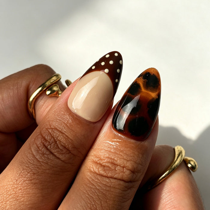 Warm almond press on nails, nude beige, tortoiseshell marbling, gold band, red dots, 3D swirl and chocolate French tip