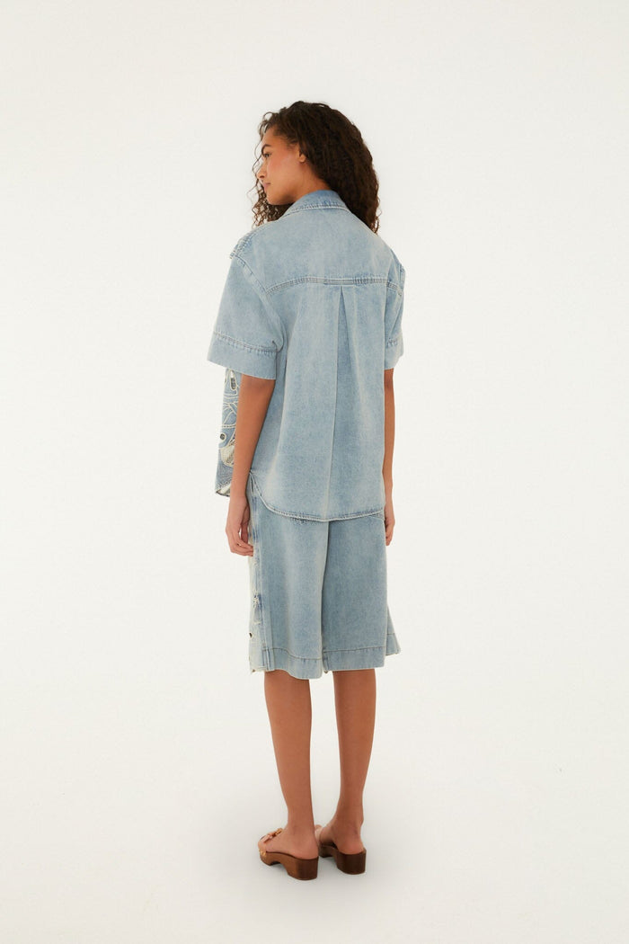 FARM Rio model wearing the Denim Sea Desire Embroidered Short Sleeve Shirt