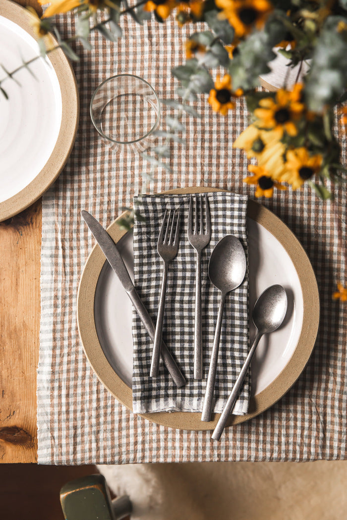 Farmhouse Gingham Linen Napkins — checked napkins at a dinner setting; Farmhouse Pottery