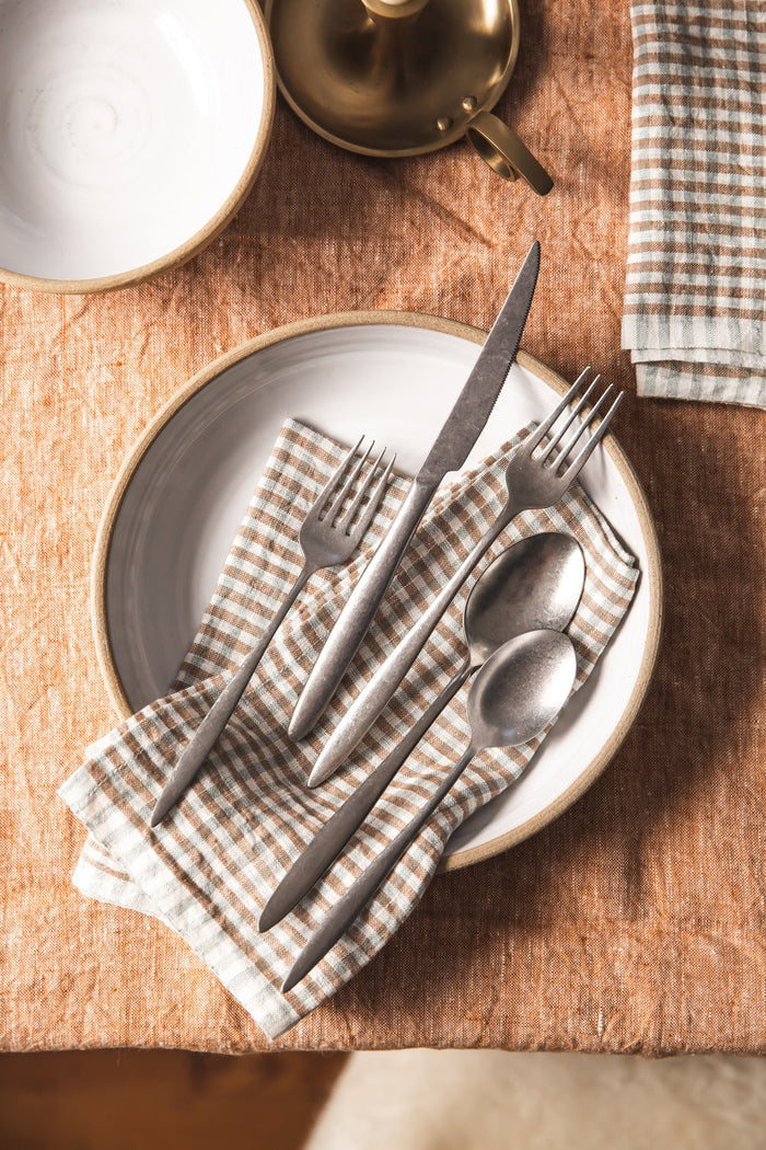 Farmhouse Gingham Linen Napkins — folded napkin beneath cutlery; Farmhouse Pottery