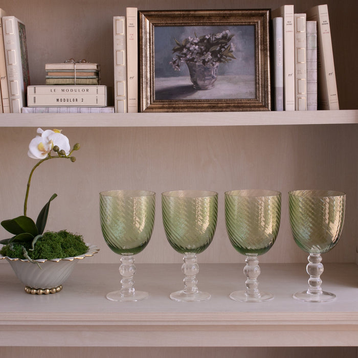 Beatriz Ball Glass French Swirl All Purpose — Four matching goblets beneath a bookshelf