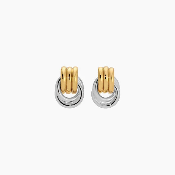 Pair of gold and silver hoop earrings on a white background