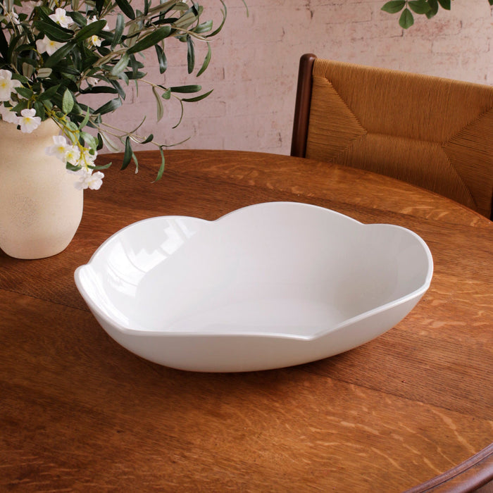 Beatriz Ball Vida Amelia Extra Large Oval Bowl White — Empty bowl beside an upholstered chair