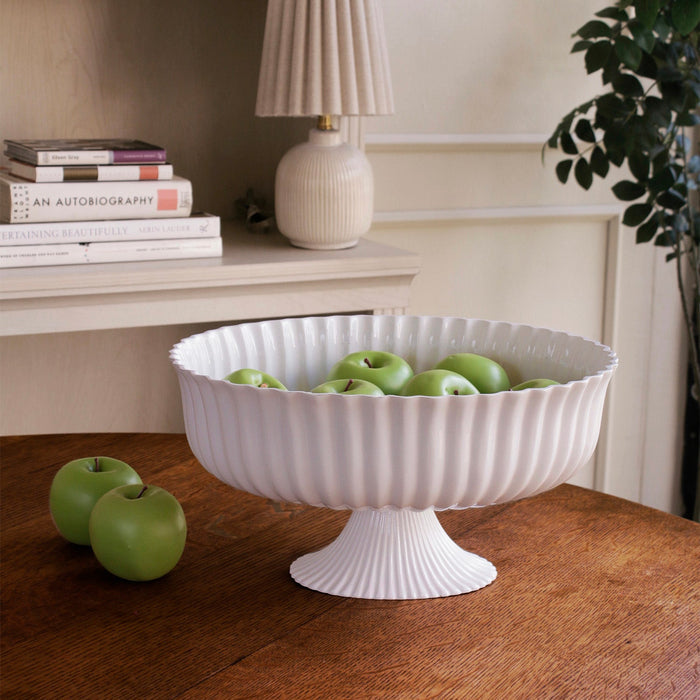 Beatriz Ball Vida Vienna Large Centerpiece White — With green apples beside books and a lamp