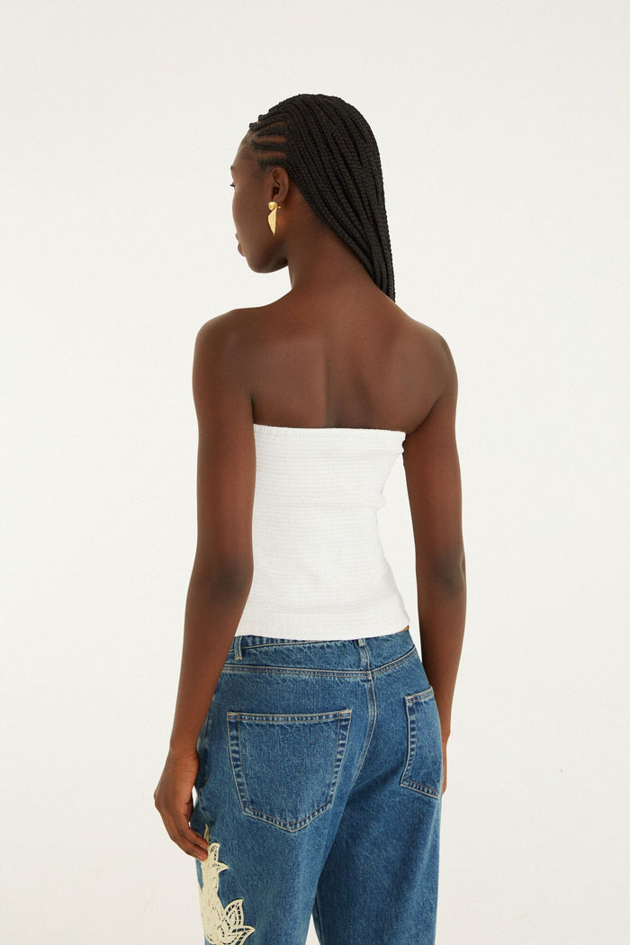 FARM Rio model wearing the White Smocked Strapless Top